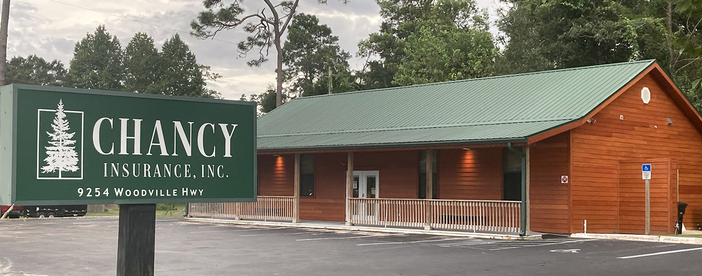 Chancy Insurance sign in front of building.